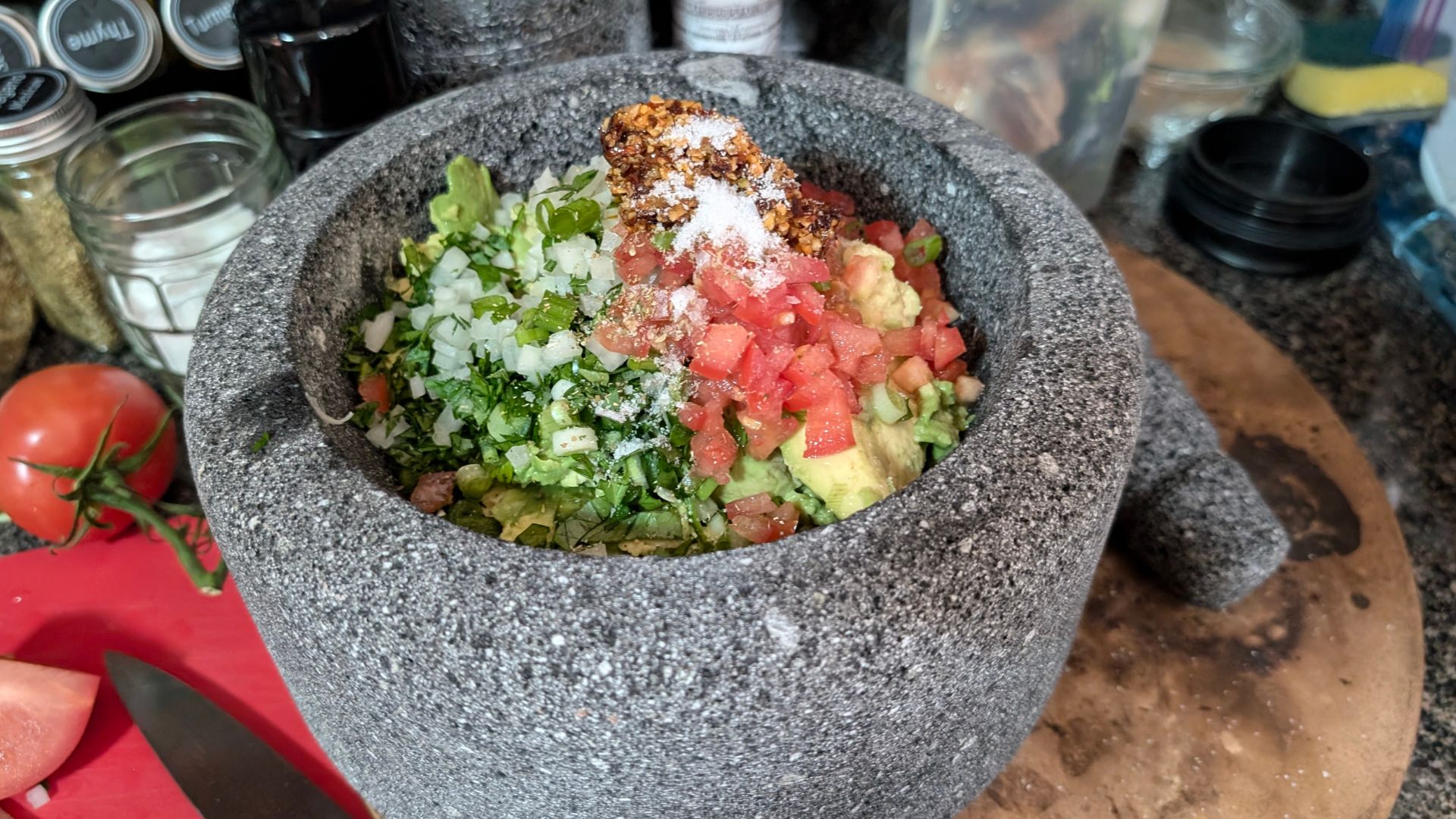 A mocajete filled with pico de gallo.